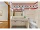 Vintage bathroom features a double sink, colorful tile accents, and unique design at 6008 S Van Gordon St, Littleton, CO 80127