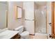 Bathroom featuring a white vanity, toilet, and a glass-enclosed shower stall at 6008 S Van Gordon St, Littleton, CO 80127