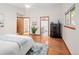 Primary bedroom features hardwood floors, ceiling fan, large window, and ensuite bath at 6008 S Van Gordon St, Littleton, CO 80127