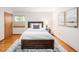 Cozy bedroom with hardwood floors, modern décor, and a view from the window at 6008 S Van Gordon St, Littleton, CO 80127