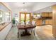 Dining area with bay window, kitchen and view of the backyard through sliding doors at 6008 S Van Gordon St, Littleton, CO 80127