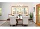 Elegant dining room with a beautiful bay window and stylish chairs and table setting at 6008 S Van Gordon St, Littleton, CO 80127