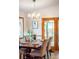 Dining area featuring modern chandelier and sliding glass doors to backyard at 6008 S Van Gordon St, Littleton, CO 80127