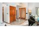 Bright entryway featuring tile flooring, coat closet, and modern light fixture at 6008 S Van Gordon St, Littleton, CO 80127