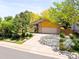Charming home exterior with stone accents, wood siding, and well-manicured landscaping at 6008 S Van Gordon St, Littleton, CO 80127