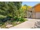 Home exterior featuring stone accents, mature trees, and inviting front porch at 6008 S Van Gordon St, Littleton, CO 80127