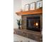 Close up of stone fireplace with wooden mantel at 6008 S Van Gordon St, Littleton, CO 80127