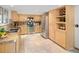 Kitchen showcasing stainless appliances, granite counters, light wood cabinetry and tile floors at 6008 S Van Gordon St, Littleton, CO 80127