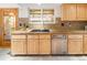 Kitchen featuring light wood cabinetry, stainless appliances, granite counters and tile floors at 6008 S Van Gordon St, Littleton, CO 80127