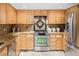 Kitchen featuring stainless appliances, light wood cabinets, granite counters, and tile backsplash at 6008 S Van Gordon St, Littleton, CO 80127