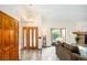 Open concept living room with high ceilings, front door, and a cozy bay window at 6008 S Van Gordon St, Littleton, CO 80127