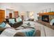 Cozy living room with a stone fireplace, comfortable seating, and natural light at 6008 S Van Gordon St, Littleton, CO 80127