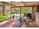 Covered patio with outdoor dining set and views of the landscaped backyard at 6008 S Van Gordon St, Littleton, CO 80127