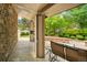 Covered porch with stone flooring, stone wall, and comfortable seating area at 6008 S Van Gordon St, Littleton, CO 80127