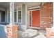 Inviting front porch with a red brick accent wall and a 'Home Sweet Home' doormat at 2855 Rock Creek Cir # 191, Superior, CO 80027