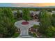 Aerial shot of luxury home, showcasing lush landscaping, a circular driveway, and stunning mountain views at 4030 E Forbes Ct, Greenwood Village, CO 80121