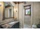 Elegant bathroom featuring a decorative mirror, marble countertop, and tiled shower at 4030 E Forbes Ct, Greenwood Village, CO 80121