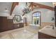 Luxury bathroom featuring dual vanities, a soaking tub, and exposed beam ceilings at 4030 E Forbes Ct, Greenwood Village, CO 80121