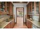 Butler's pantry with custom cabinetry, granite countertops, and a wine refrigerator at 4030 E Forbes Ct, Greenwood Village, CO 80121