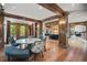 Charming dining area with wood beams, hardwood floors, and a view into the kitchen and other living areas at 4030 E Forbes Ct, Greenwood Village, CO 80121