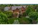 Grand home with mature landscaping and architectural lighting, creating a welcoming ambiance at 4030 E Forbes Ct, Greenwood Village, CO 80121