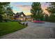 An amazing estate featuring lush lawns, colorful landscaping, and a circular driveway at 4030 E Forbes Ct, Greenwood Village, CO 80121