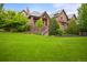 Picturesque home featuring a well-manicured lawn and elegant stone and brick exterior, enhancing curb appeal at 4030 E Forbes Ct, Greenwood Village, CO 80121