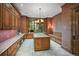 Spacious office with custom wood cabinets, large window, granite countertops, and decorative chandelier at 4030 E Forbes Ct, Greenwood Village, CO 80121