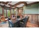 Home office featuring wood trim, large windows, and a leather-topped executive desk at 4030 E Forbes Ct, Greenwood Village, CO 80121