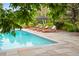 Stunning pool with lounge chairs on a stone patio, perfect for relaxation and entertaining at 4030 E Forbes Ct, Greenwood Village, CO 80121