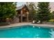 Sparkling backyard pool and stone patio area with seating at 4030 E Forbes Ct, Greenwood Village, CO 80121