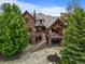 Backyard aerial view featuring a brick home, stone patio, steps, and landscaping at 4030 E Forbes Ct, Greenwood Village, CO 80121