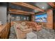 Home theater with leather recliners, large screen, wood trim and ceiling beams at 4030 E Forbes Ct, Greenwood Village, CO 80121
