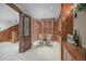 Wine cellar featuring beautiful wood shelving, ornate door, and small table with chairs at 4030 E Forbes Ct, Greenwood Village, CO 80121