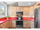 Modern kitchen with red countertops and stainless steel appliances at 680 Crescent Ln, Lakewood, CO 80214