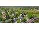 An aerial view showing mature trees and green landscaping of a suburban neighborhood with park, trails and fields nearby at 9605 Carr St, Broomfield, CO 80021