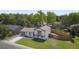 Aerial view of a well-maintained home with a large, fenced backyard, vibrant green grass, and mature trees at 9605 Carr St, Broomfield, CO 80021