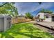 The backyard includes a storage shed and a spacious lawn, all enclosed by a wooden fence at 9605 Carr St, Broomfield, CO 80021