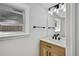 Modern bathroom features a wood vanity, white countertop, and stylish lighting fixture at 9605 Carr St, Broomfield, CO 80021