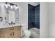 Bathroom features a vanity with a wood cabinet, and a modern tiled shower and tub combination at 9605 Carr St, Broomfield, CO 80021