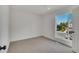 Bright bedroom with plush carpeting and a large window overlooking the neighborhood at 9605 Carr St, Broomfield, CO 80021