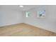 Light-filled bedroom with hardwood floors and two windows bringing in natural light at 9605 Carr St, Broomfield, CO 80021