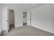 Bedroom with carpet and doors to a hallway, bedroom and to other living space at 9605 Carr St, Broomfield, CO 80021