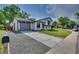 Exterior view showing a two-story house with a long driveway and a well-maintained front lawn at 9605 Carr St, Broomfield, CO 80021
