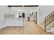 Open kitchen featuring white cabinets, stainless steel appliances, and breakfast bar seating at 9605 Carr St, Broomfield, CO 80021