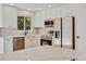Modern kitchen with white cabinets, stainless steel appliances, and a large center island at 9605 Carr St, Broomfield, CO 80021