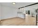 Open concept kitchen with stainless appliances and light wood floors at 9605 Carr St, Broomfield, CO 80021
