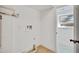 Bright laundry room boasts modern hookups, white walls, and wood-look vinyl flooring at 9605 Carr St, Broomfield, CO 80021