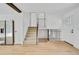 Open-concept living room featuring light wood floors, a staircase, and natural light at 9605 Carr St, Broomfield, CO 80021