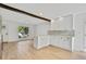 Open-concept living room featuring light wood floors, staircase, and open kitchen at 9605 Carr St, Broomfield, CO 80021